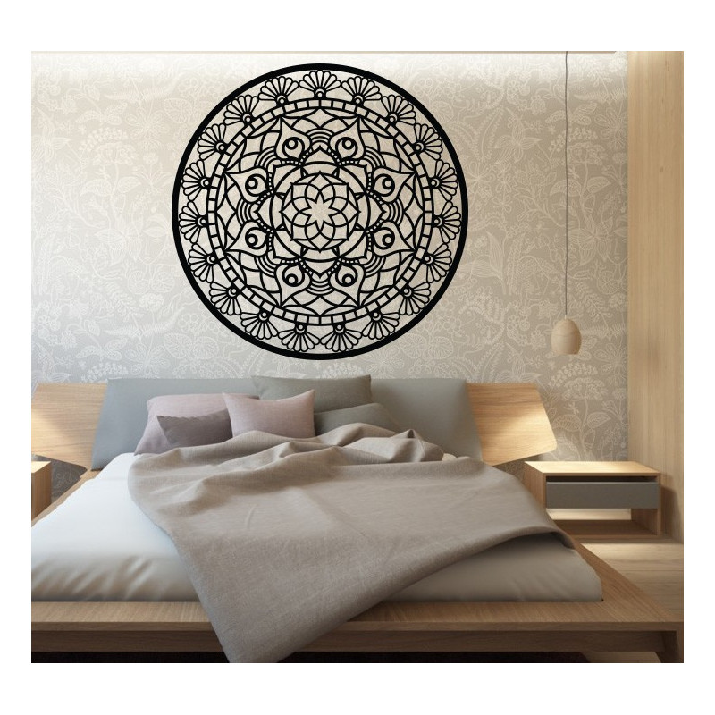 The mandala of life is rounded by a wooden picture on a wall made of SUSEN